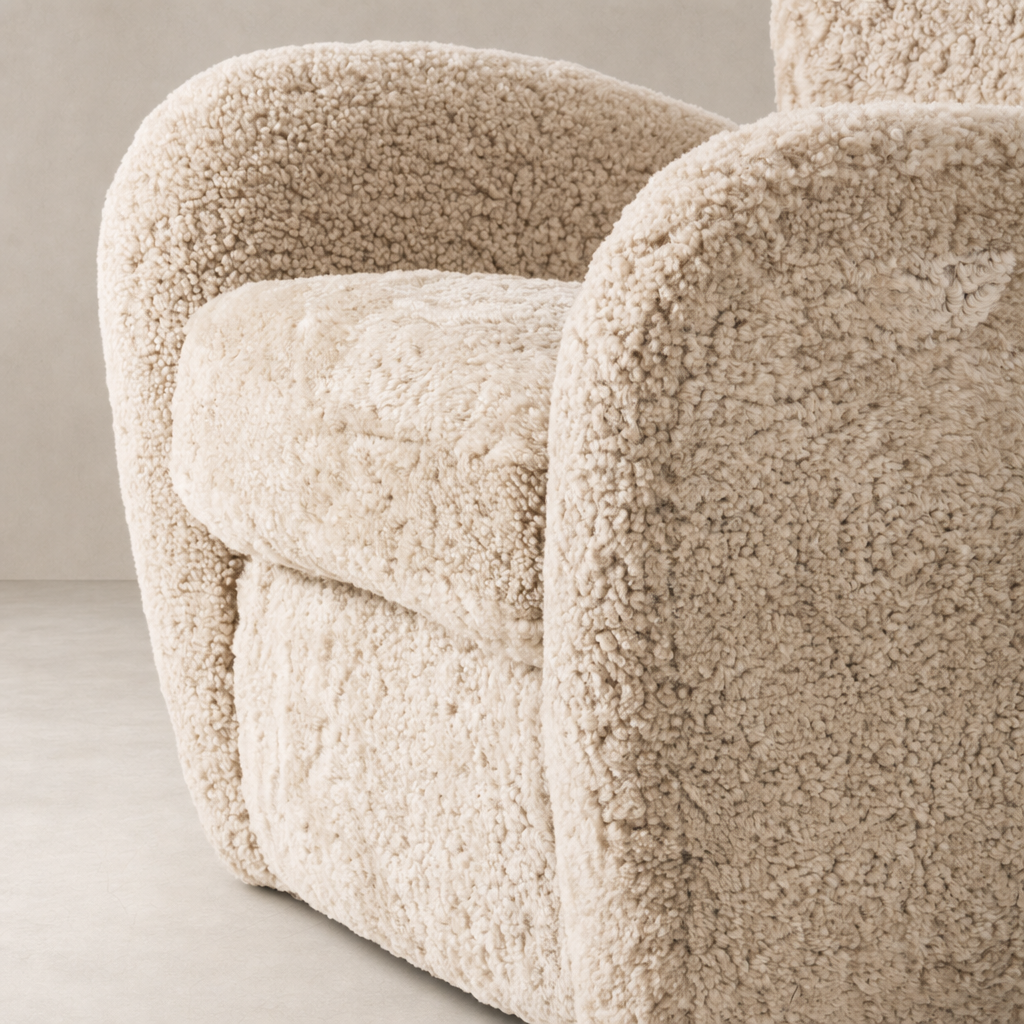 Beige shearling Elodie Chair showcasing plush upholstery and rounded armrests.