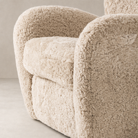 Beige shearling Elodie Chair showcasing plush upholstery and rounded armrests.