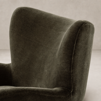 Elodie Chair in Monte Olive with soft velvet upholstery and curved high back design.