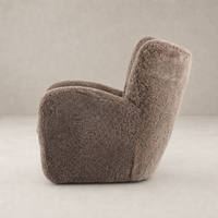 Elodie Chair in taupe shearling with a rounded, plush design and cozy texture.