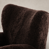 Textured cocoa shearling Elodie Chair with curved backrest for comfort.