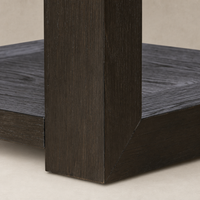 Close-up of Otis End Table showcasing its dark wood finish and angular design.