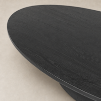 Ronan Coffee Table in worn black features a sleek oval top design.