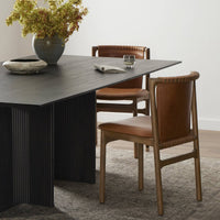 Detail of the Marbella Dining Chair featuring a warm leather seat and stylish wooden frame.