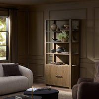 Odessa Bookcase in warm natural oak features open shelves and a lower cabinet.