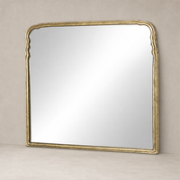 Seine Mantel Mirror with an antiqued gold leaf frame and elegant curved edges.