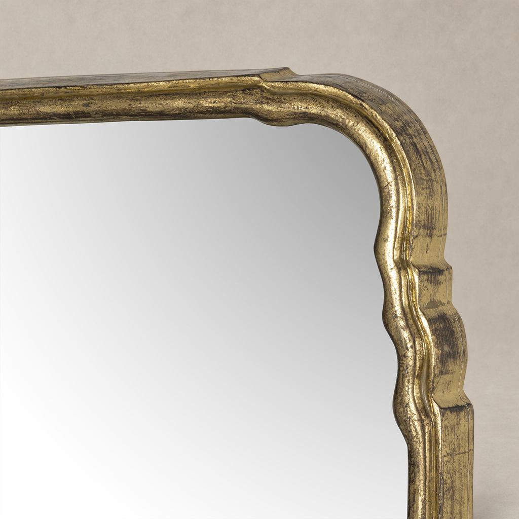 Close-up of the Seine Mantel Mirror's intricately designed antiqued gold leaf frame.