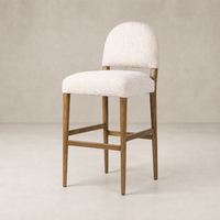 Corinne Bar + Counter Stool in Somerton Ash with soft, textured upholstery and wooden legs.
