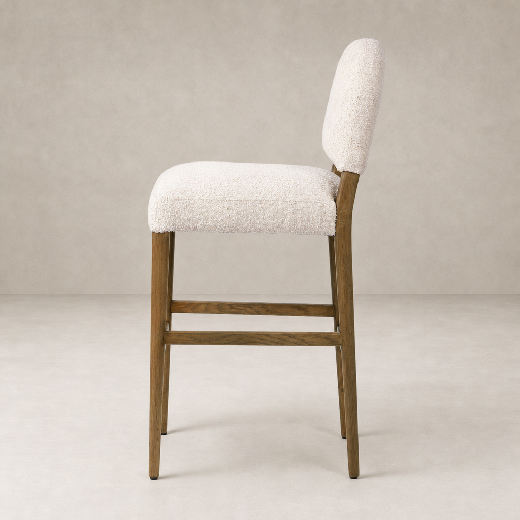 Corinne Bar + Counter Stool in Somerton Ash with textured light fabric and wooden legs.