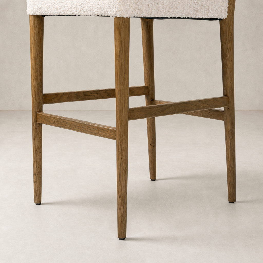Corinne Bar + Counter Stool in Somerton Ash showcasing wooden legs and cozy upholstery.