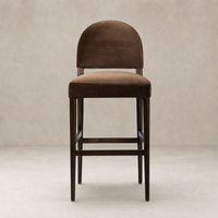Corinne Bar + Counter Stool in Sapphire Coco, featuring a plush curved back and wooden legs.