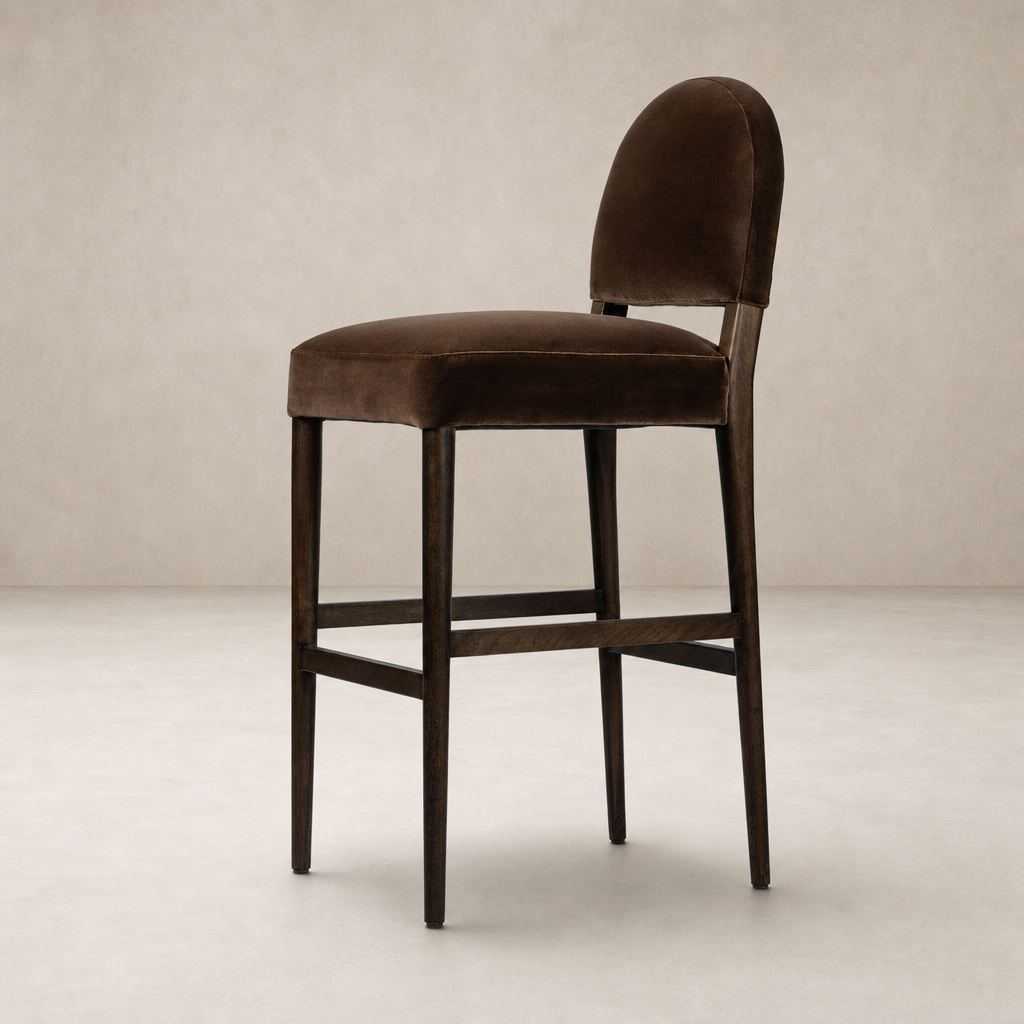 Corinne Bar + Counter Stool in Sapphire Coco with a sleek, curved backrest and plush upholstery.