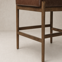 Fern Bar + Counter Stool in Altair Sienna with wooden legs and rich leather seat.