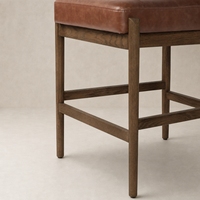 Fern Bar + Counter Stool in taupe shearling with a stylish wooden frame.