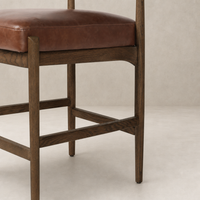 Taupe shearling Fern Bar + Counter Stool with rich brown leather seat and wooden frame.