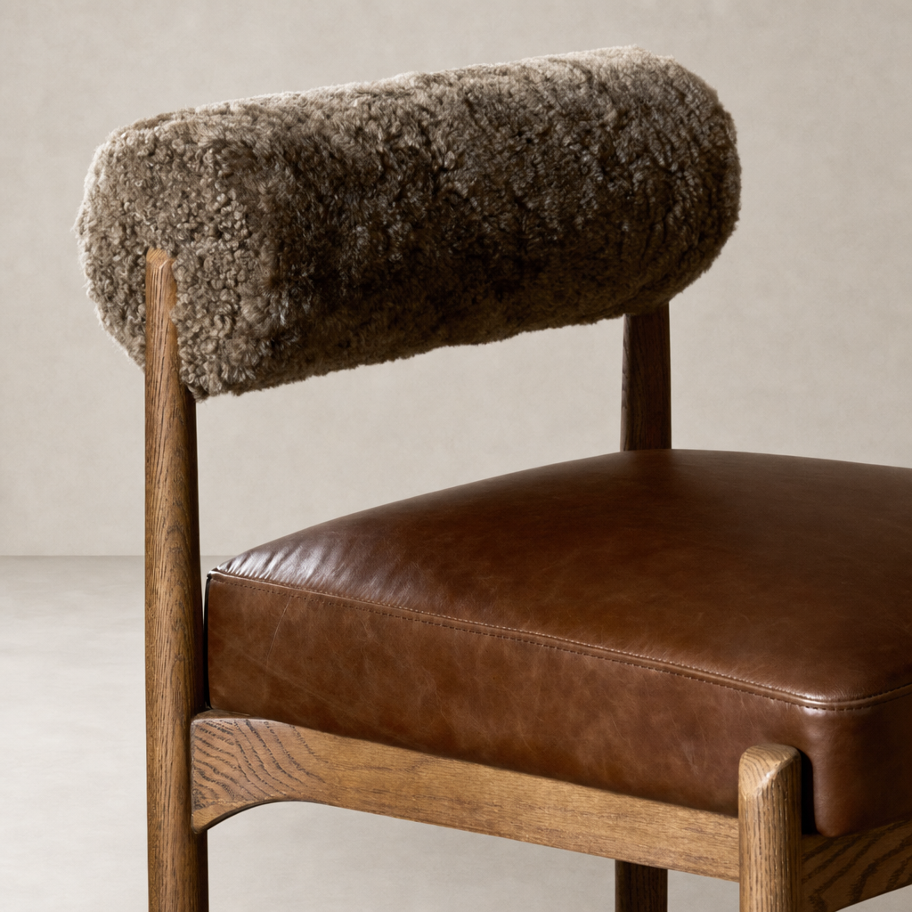 Taupe shearling Fern Bar + Counter Stool with leather seat and wooden legs.