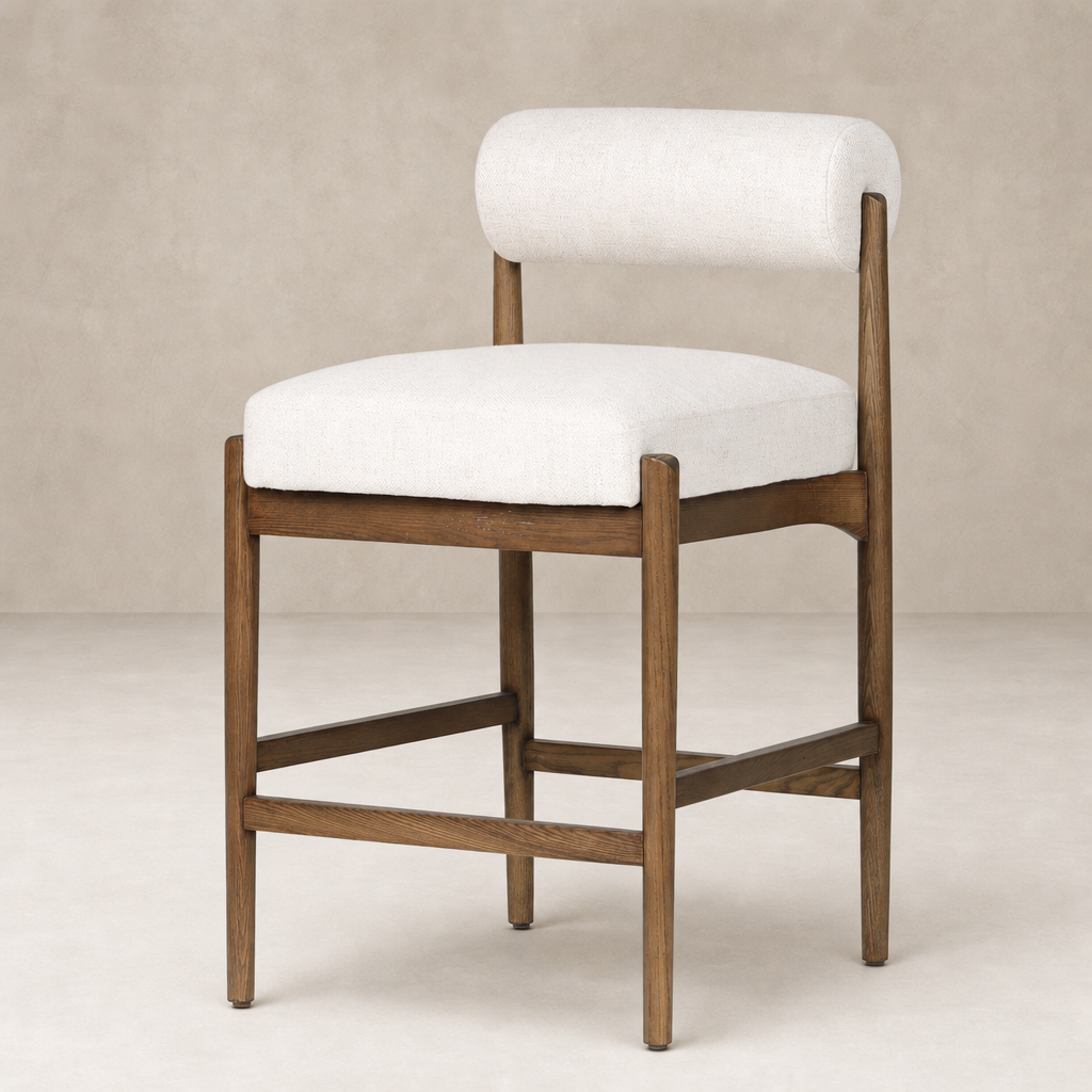 Fern Bar + Counter Stool in Dover Crescent features a soft, rounded back and wood frame.