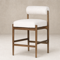 Fern Bar + Counter Stool in Dover Crescent features a soft, rounded back and wood frame.