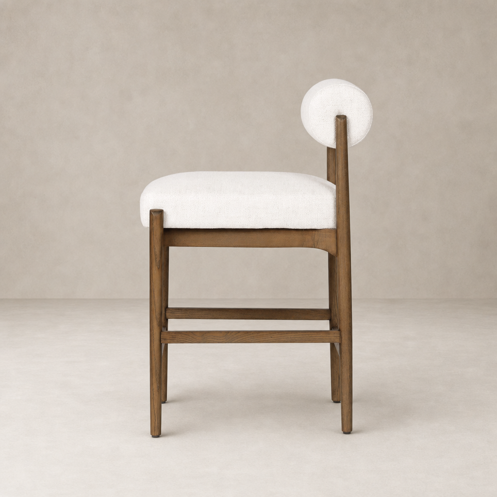 Fern Bar + Counter Stool in Dover Crescent features a sleek wooden frame and round backrest.