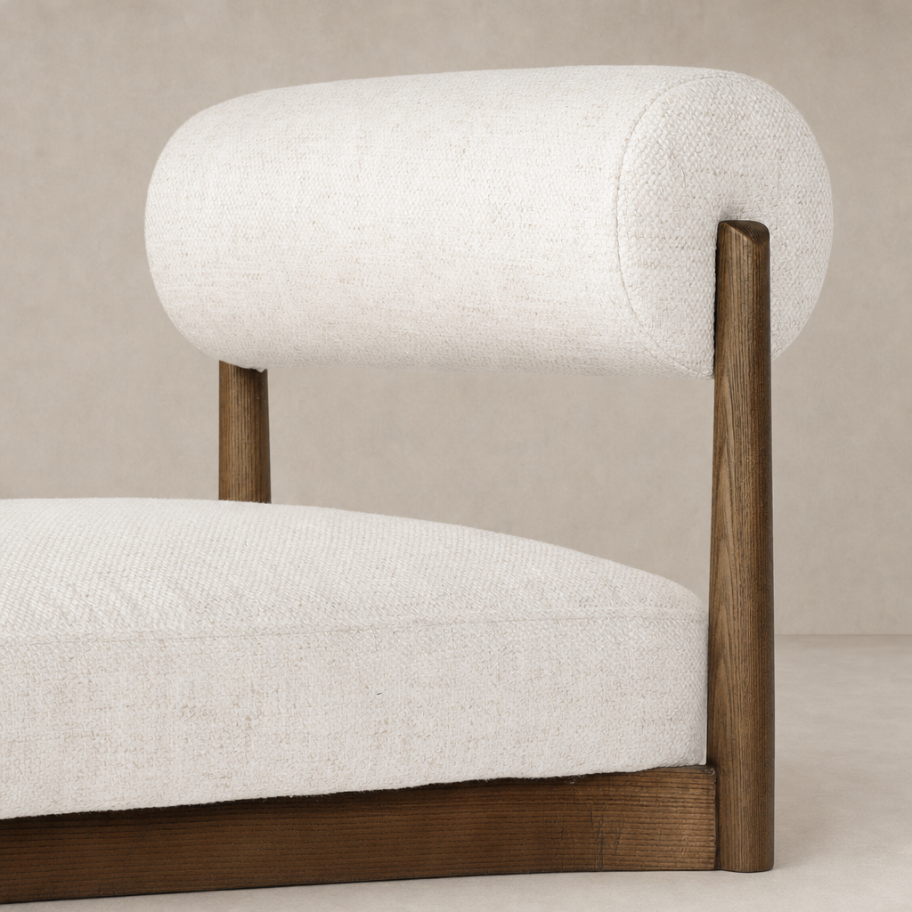 Fern Bar + Counter Stool in Dover Crescent featuring a sleek, rounded back and wooden legs.