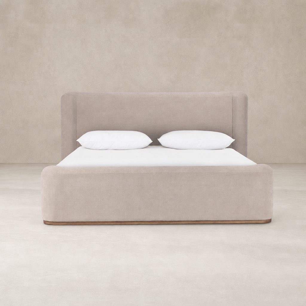 Holland Sand upholstered bed with soft edges and comfortable white pillows.