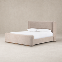 Contemporary bed in Holland Sand upholstery with plush cushioning and rounded edges.