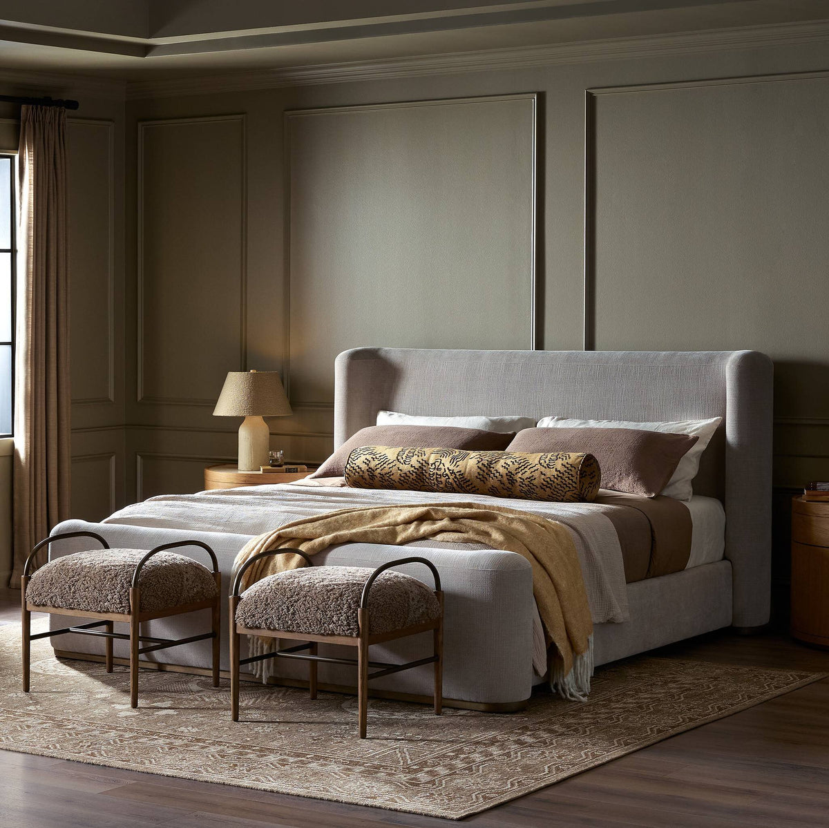 Modern bed in Holland Sand fabric, styled with decorative pillows and cozy throws.