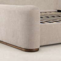 Holland Sand bed featuring soft fabric upholstery and a sturdy wooden base.