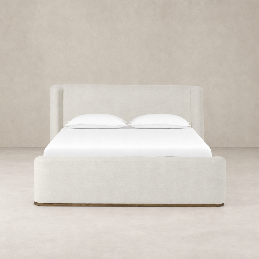 Modern bed in Crypton Nomad Snow fabric with plush headboard and clean lines.