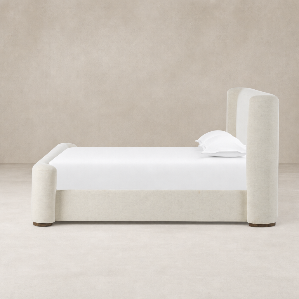 Modern bed in Crypton Nomad Snow, featuring rounded edges and plush upholstery.