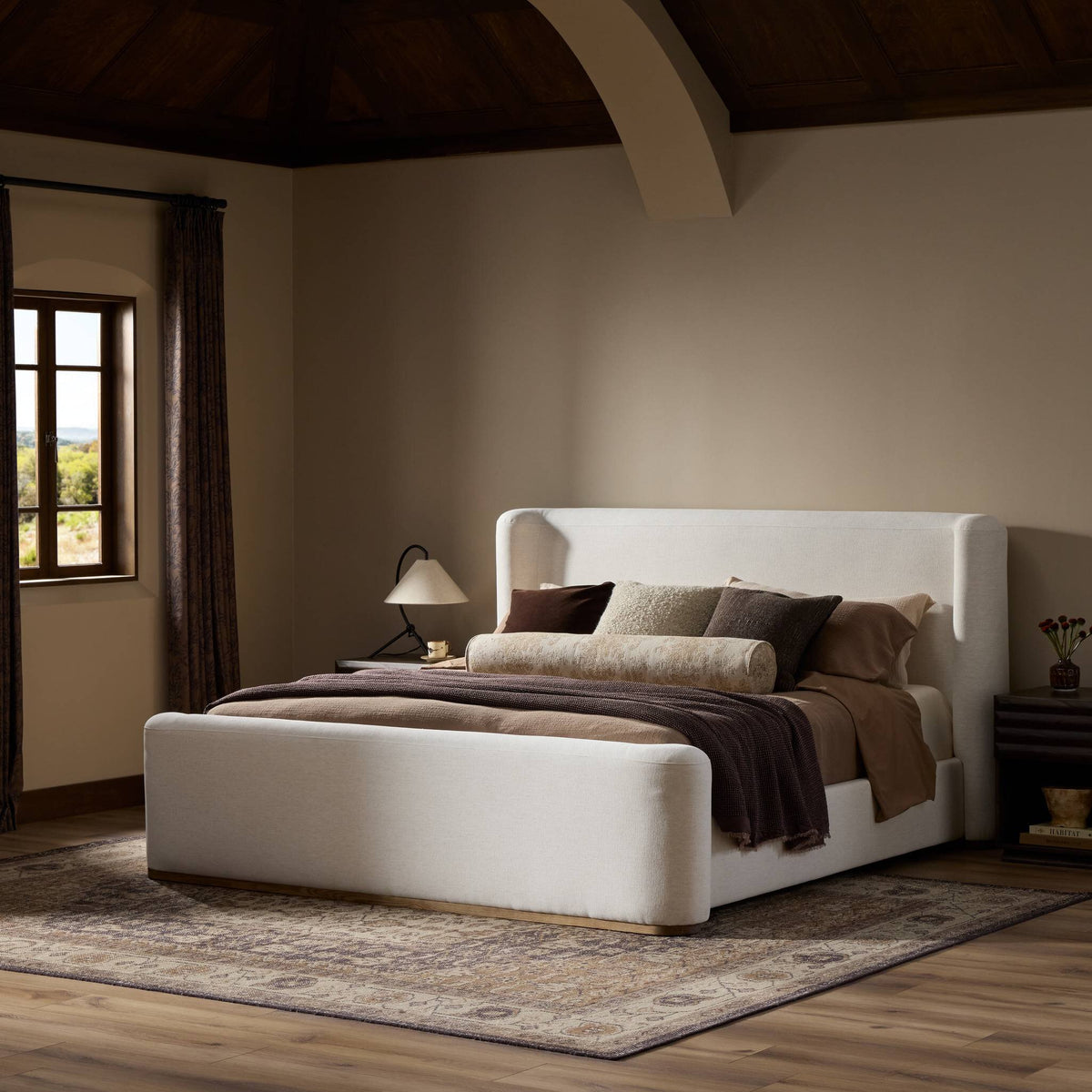 Stylish bed in Crypton Nomad Snow with plush pillows and decorative throw.
