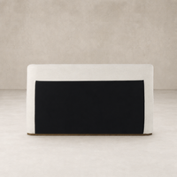 Modern bed in Crypton Nomad Snow with a sleek black accent panel.