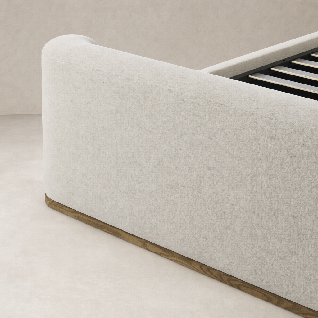 Curved bed in Crypton Nomad Snow with wooden base and smooth fabric finish.