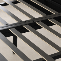Black bed frame slats with wood support beams for sturdy mattress support.