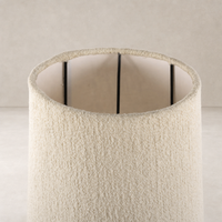 Black wrought iron floor lamp featuring a textured cream shade.