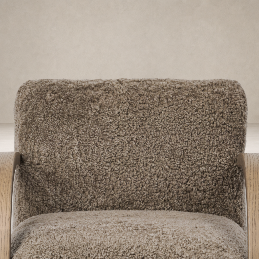 Taupe shearling Roan Chair showcasing a plush, textured upholstery and wooden armrests.