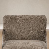 Taupe shearling Roan Chair showcasing a plush, textured upholstery and wooden armrests.
