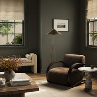 Cozy Roan Chair in cocoa shearling with curved wooden armrests in a stylish room.