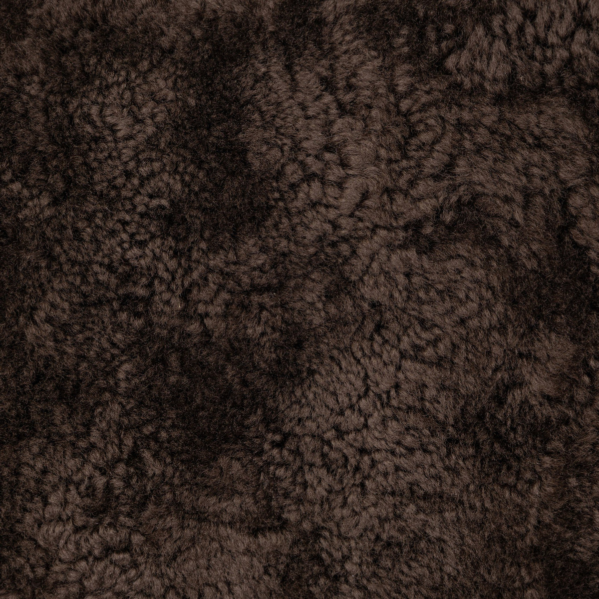 Cocoa shearling texture of the Roan Chair, showcasing its soft, fluffy surface.