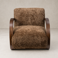 Roan Chair in amber shearling with wooden curved arms and plush texture.