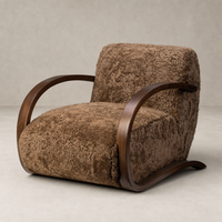Roan Chair in amber shearling with sleek wooden curved arms and plush texture.