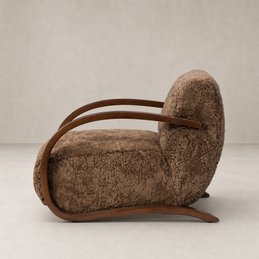 Roan Chair in amber shearling with curved wooden arms and fluffy upholstery.