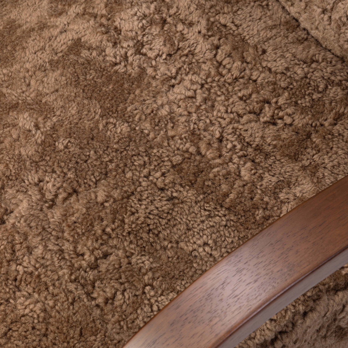 Close-up of the Roan Chair in amber shearling showcasing its soft, textured fabric.