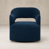 Amira Swivel Chair in Henry Navy featuring a rounded shape and plush velvet upholstery.