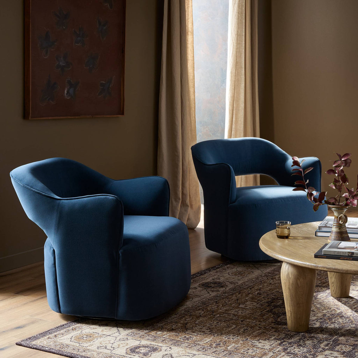 Amira Swivel Chair in Henry Navy, featuring a curved design and plush upholstery.