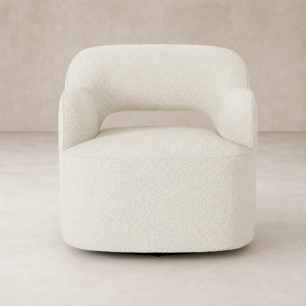 Amira Swivel Chair in natural sheepskin features a rounded silhouette and cozy armrests.