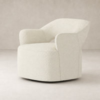 Amira Swivel Chair in Natural Sheepskin with curved arms and plush texture.