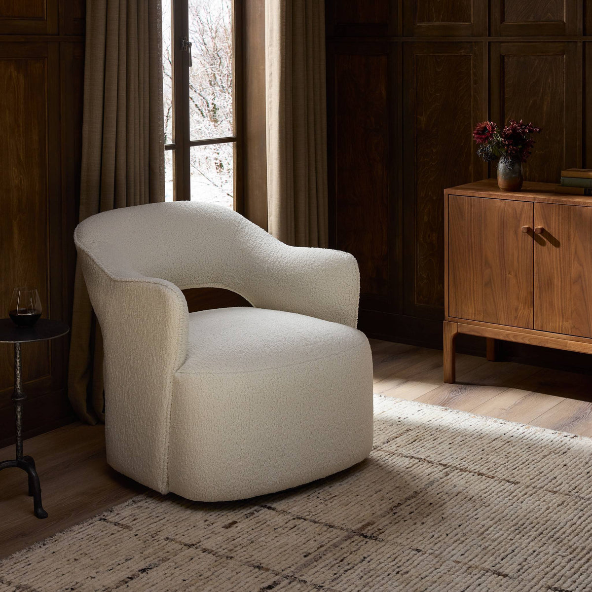 Amira Swivel Chair in natural sheepskin, featuring a curved silhouette and textured upholstery.