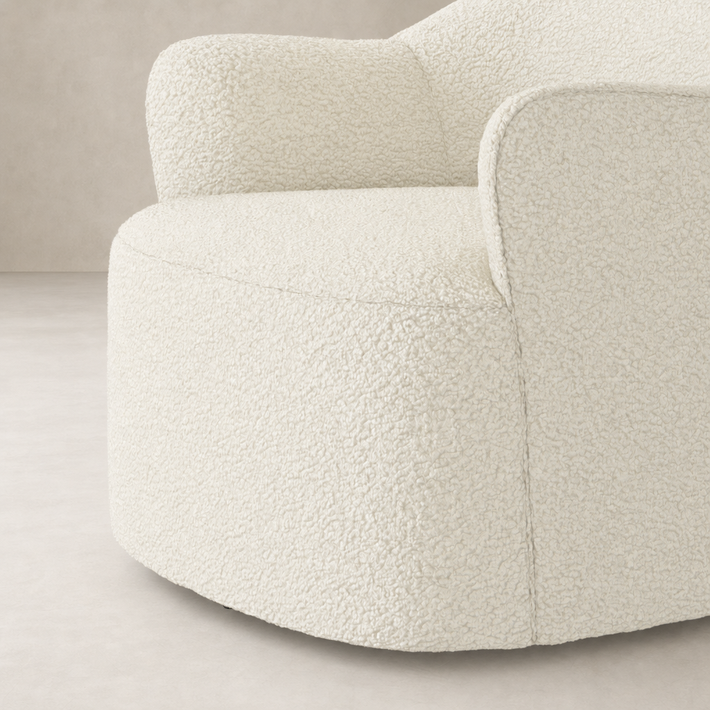 Amira Swivel Chair in Natural Sheepskin with rounded, plush design and soft texture.