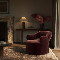 Amira Swivel Chair in Surrey Plum, featuring plush upholstery and sleek curved design.